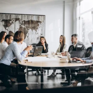 A professional team discussing digital marketing strategies with a global map background.